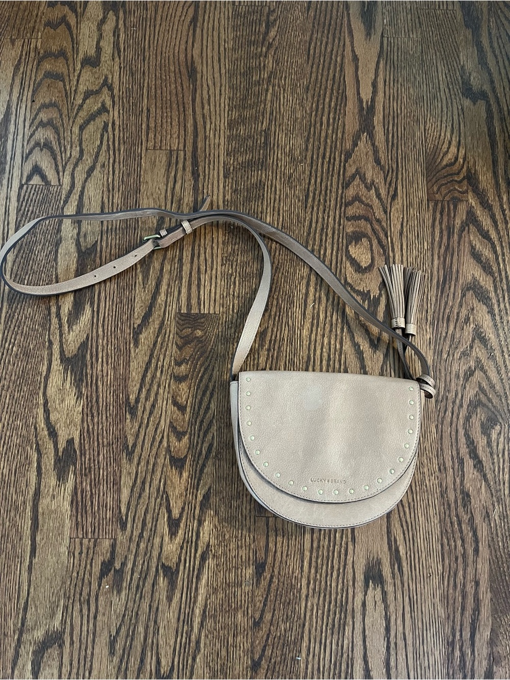 Lucky Brand Evie Saddle Crossbody Bag in Tan with Tassel and Studs